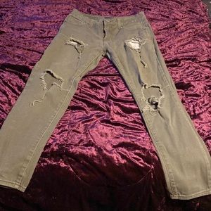Green ripped skinny jeans with black label